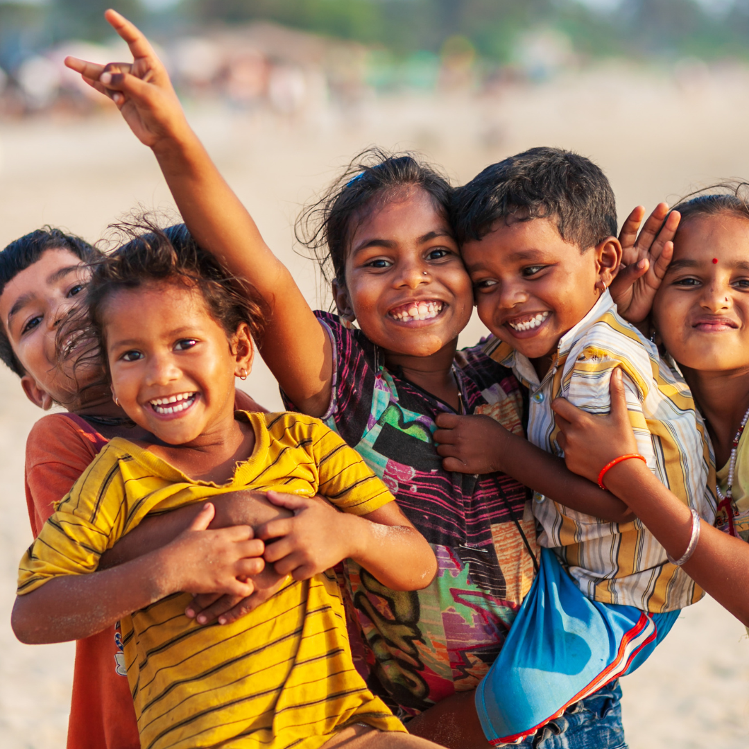 Two smiling children in a slum